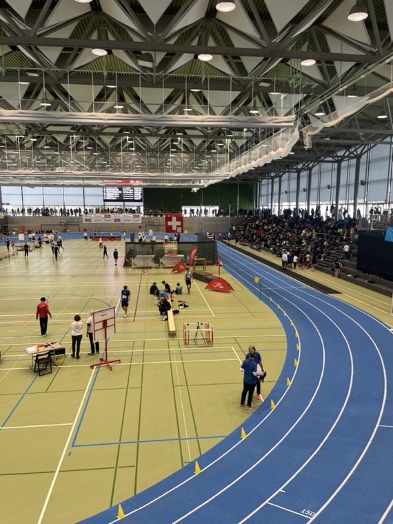 Indoor athletics hall with a Swiss flag during a meet