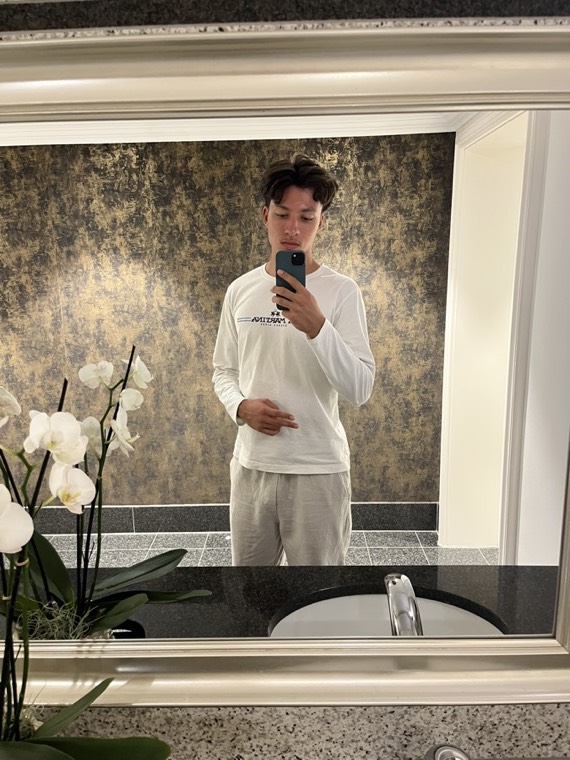 Mirror selfie in a white long-sleeve shirt