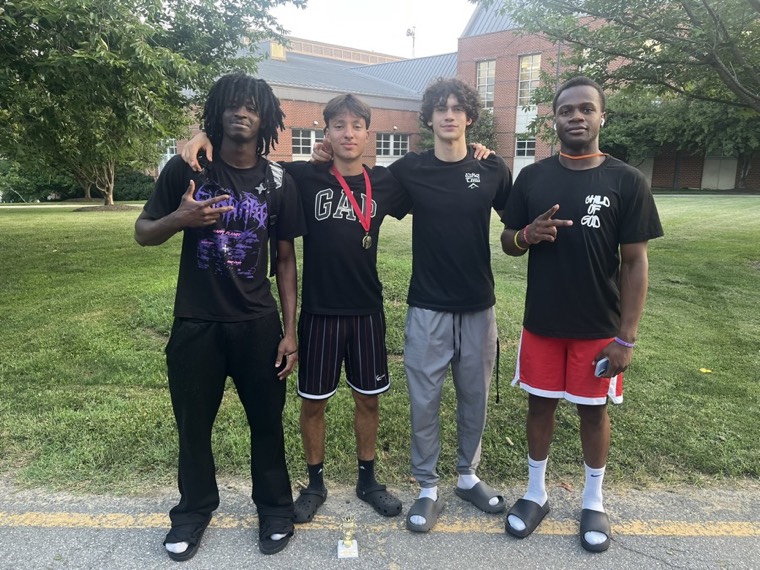 With three teammates and a trophy on campus