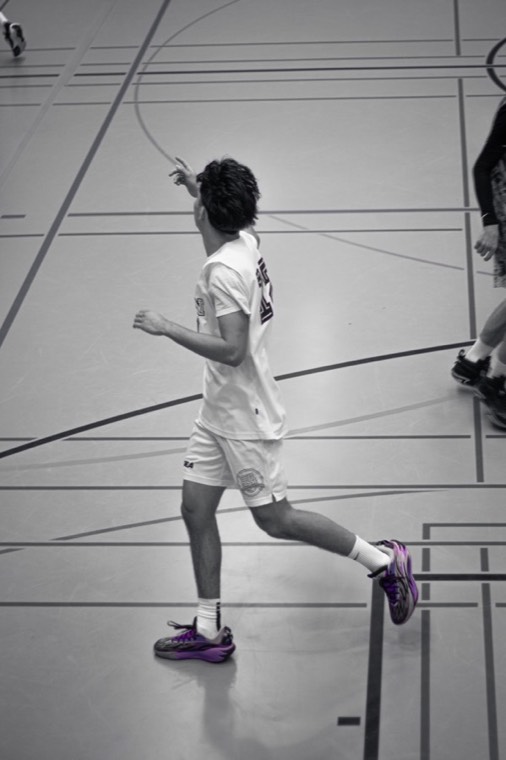Black-and-white game photo, pointing to a teammate